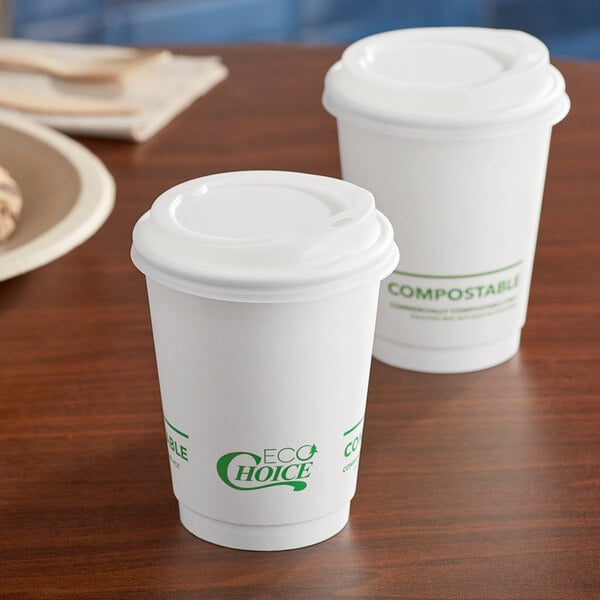 Two EcoChoice white compostable paper cups with lids on a table.