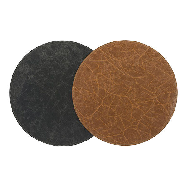 Two round faux leather Room360 placemats, one black and one brown.