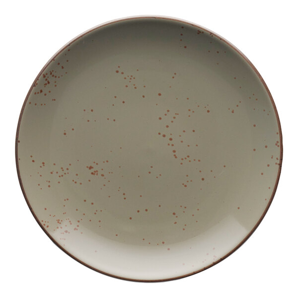 A white stoneware coupe plate with red specks.