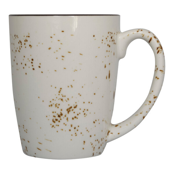 A white mug with brown speckled spots.