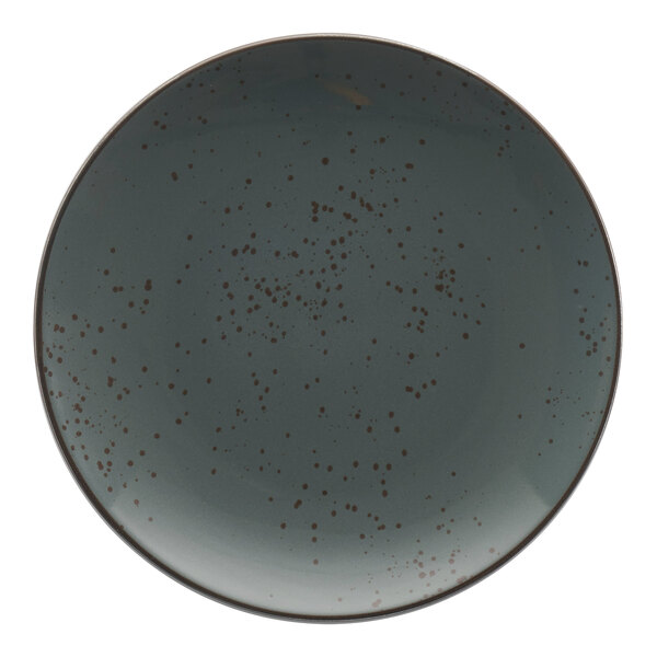 A close up of a grey International Tableware Lunar Blue stoneware coupe plate with brown specks.
