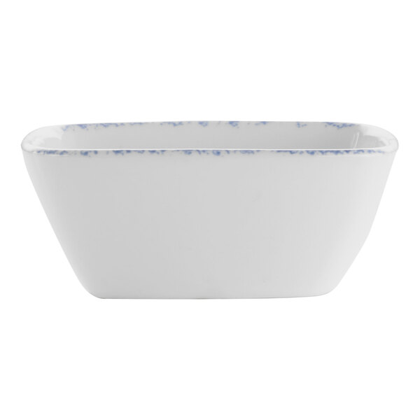 A white bowl with blue speckles on it.