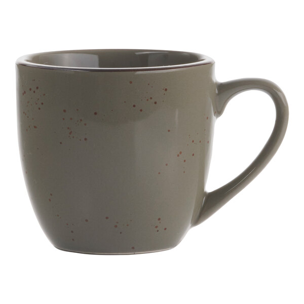 A green smoke stoneware cappuccino cup with a handle and speckled dots.