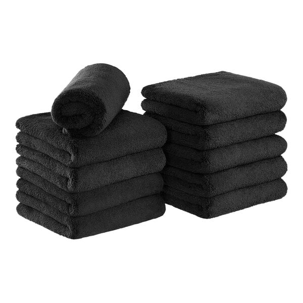 A stack of black Monarch Brands coral fleece hand towels.