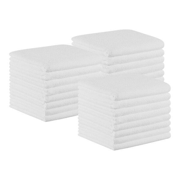 A stack of Monarch Brands white hand towels.
