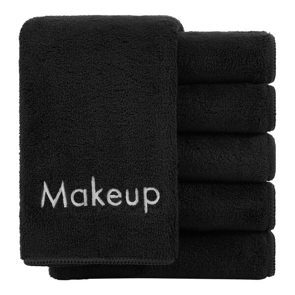A stack of black Monarch Brands makeup wash cloths with the word makeup on them.