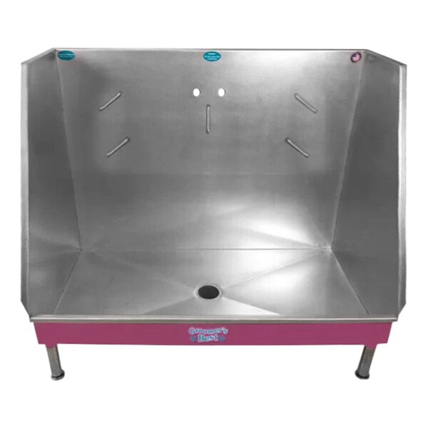 A metal walk-in dog grooming tub with a pink base and center drain.
