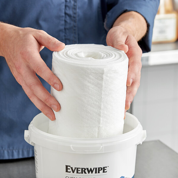 A person holding an Everwipe Chem-Ready 12" x 10" refill wiping roll.