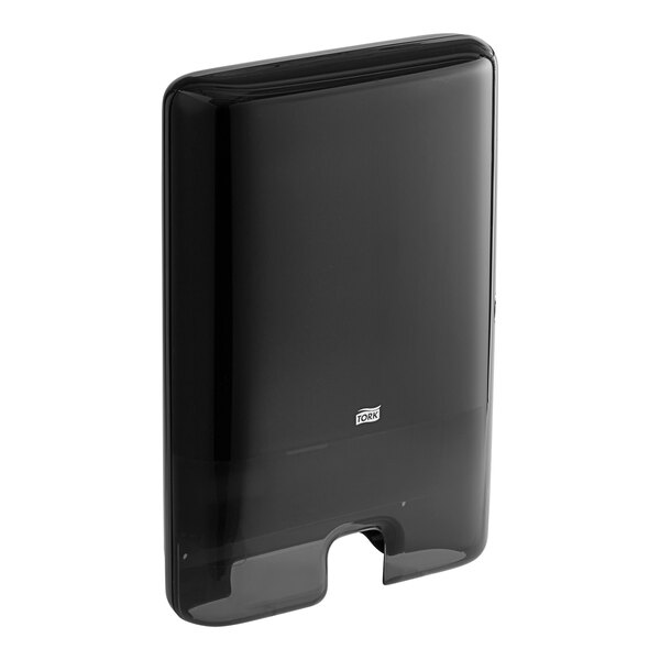 A black rectangular Tork wall mount hand towel dispenser.