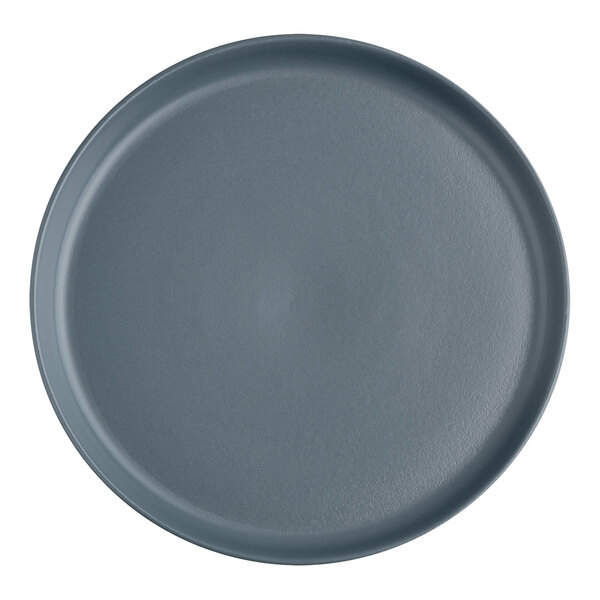 A grey round plate with a dark grey slate surface.