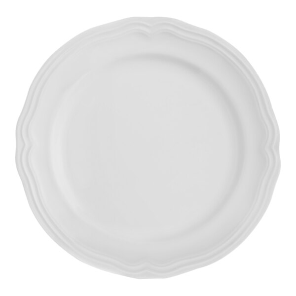 A white Arcoroc porcelain plate with a scalloped edge.