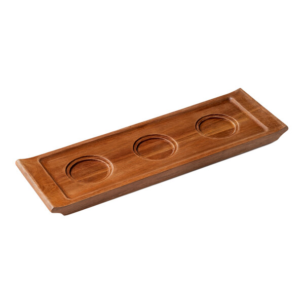 A rectangular wooden board with three wells carved into it.