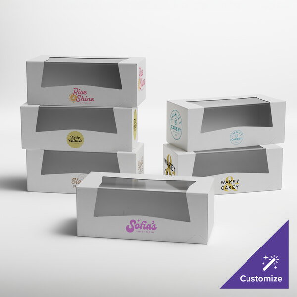 A set of white customizable bakery boxes with clear window tops, designed for packaging donuts or baked goods.