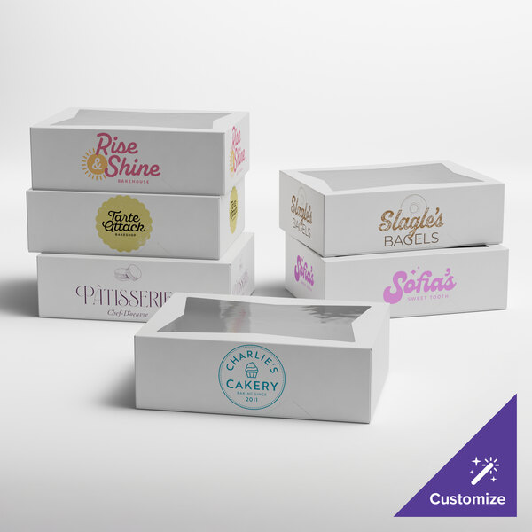 A set of white customizable bakery boxes with clear window tops, each featuring different bakery logos.