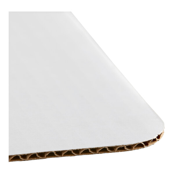 A white corrugated grease-resistant full sheet cake pad with rounded corners.