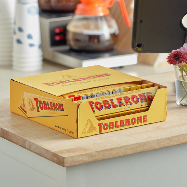 A case of Toblerone chocolate bars on a counter.