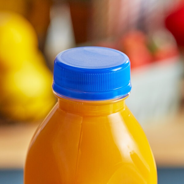 A bottle of orange juice with a Royal Blue tamper-evident cap on a counter.
