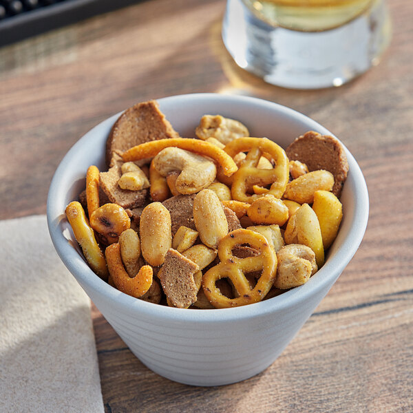 A bowl of Albanese Cajun Kicker Snack Mix on a table in a corporate office cafeteria.