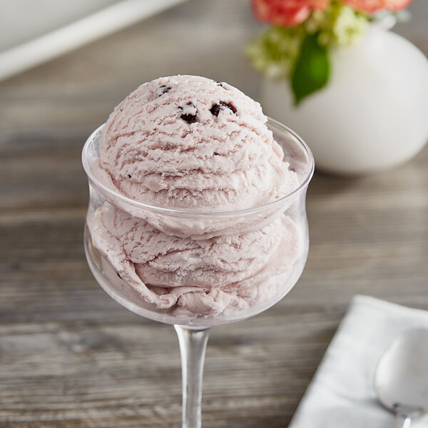 A scoop of I. Rice blueberry hard serve ice cream in a glass.