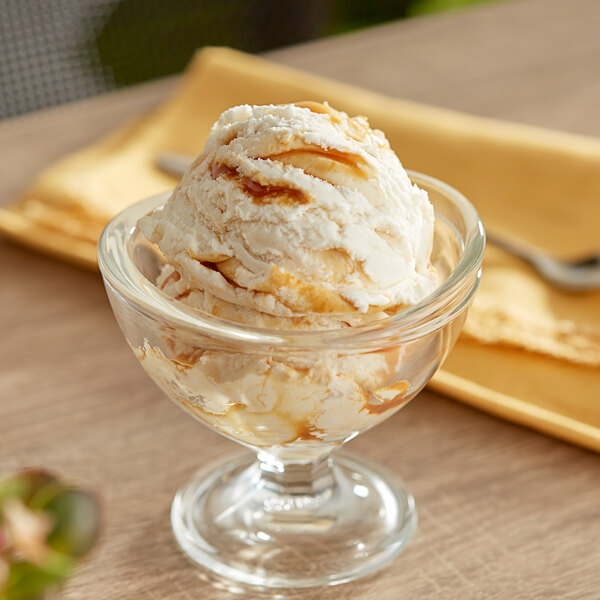 A glass bowl with I. Rice Salty Caramel Variegate ice cream and a spoon.
