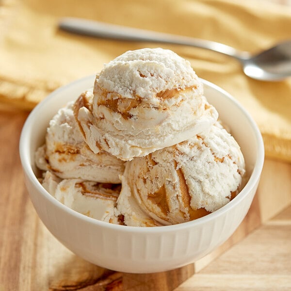 A bowl of I. Rice peanut butter variegate ice cream with a scoop in it.