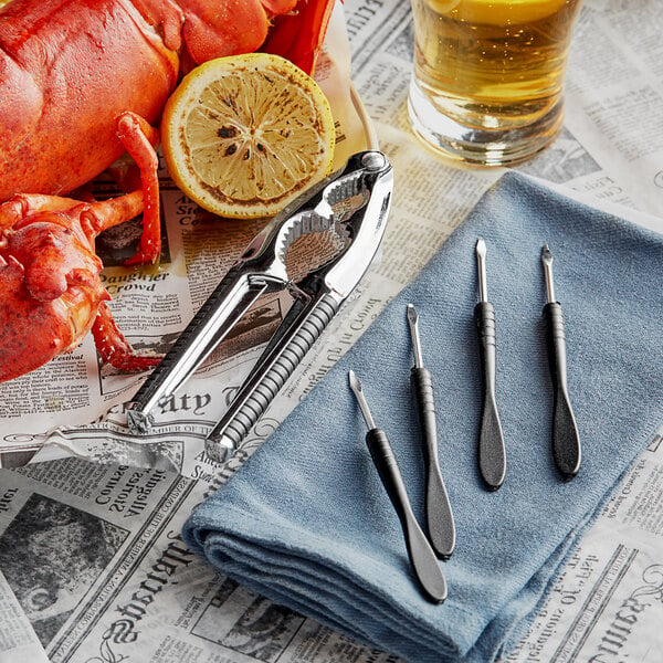 A Nantucket Seafood crab cracker set with a lemon and a lobster on a counter.