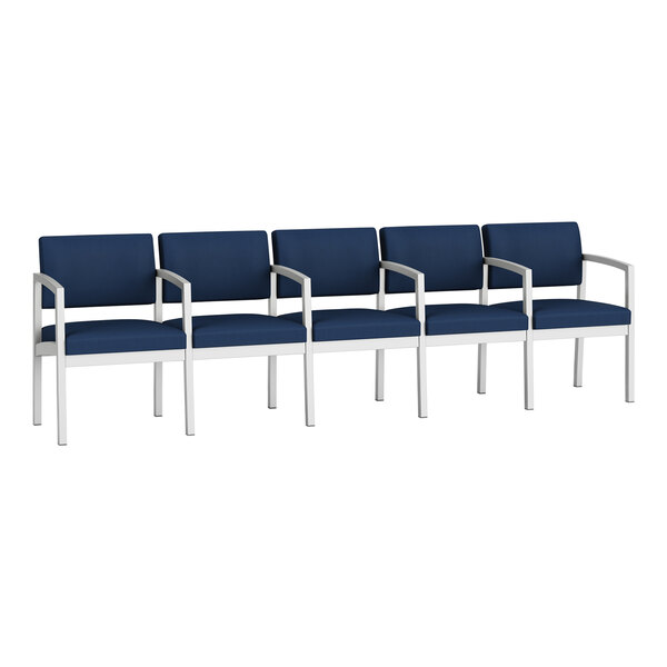 A row of Lesro blue chairs with white legs and navy blue vinyl seats.