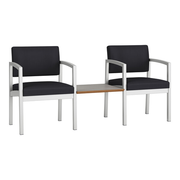 Two black Lesro Lenox guest chairs with a white table connecting them.
