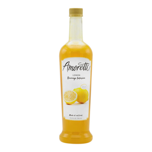 A close up of a bottle of Amoretti Lemon Beverage Infusion with a lemon cut in half on a white background.