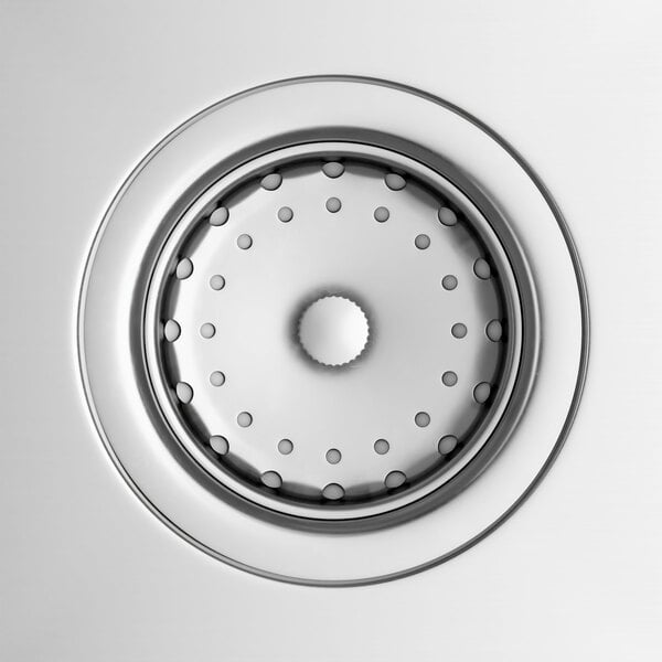 A close up of the circular hole in a stainless steel sink.