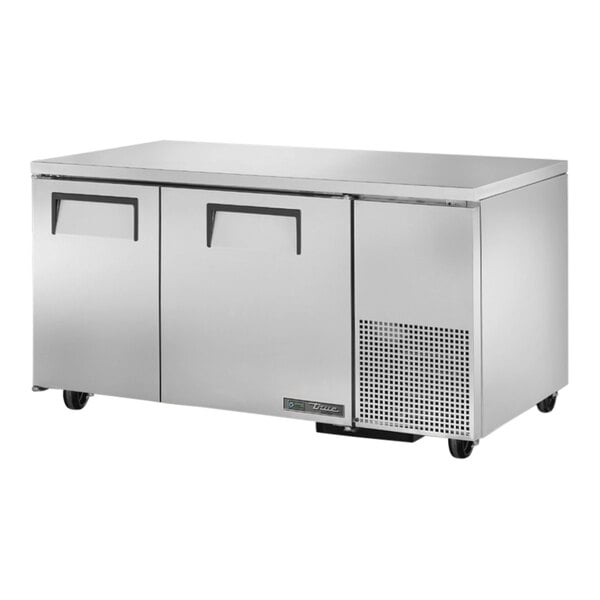 A stainless steel True undercounter freezer with two doors.