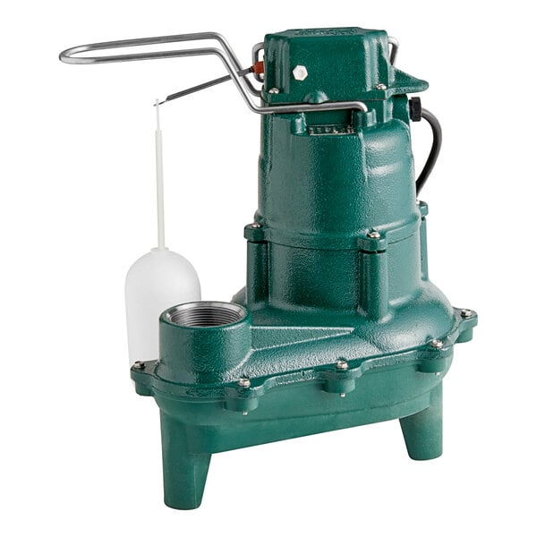 A green Zoeller M264 sewage pump with a white plastic tube attached.
