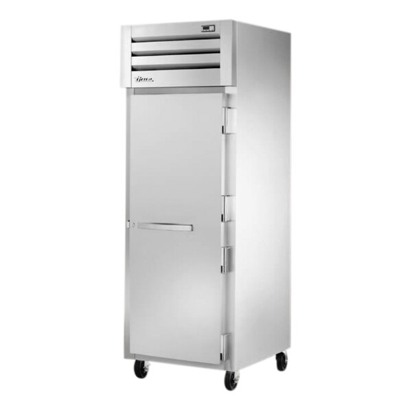 A True white reach-in freezer with silver handles and wheels.