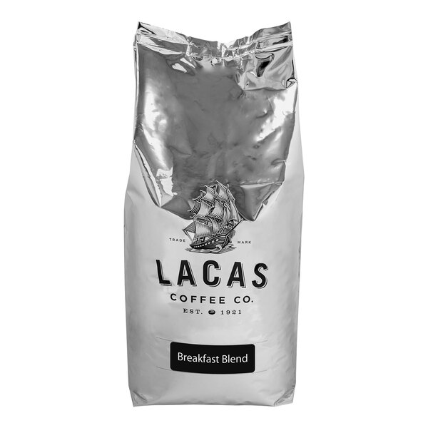 A silver bag of Lacas Coffee Town & Country Breakfast Blend Whole Bean Coffee with a logo on it.
