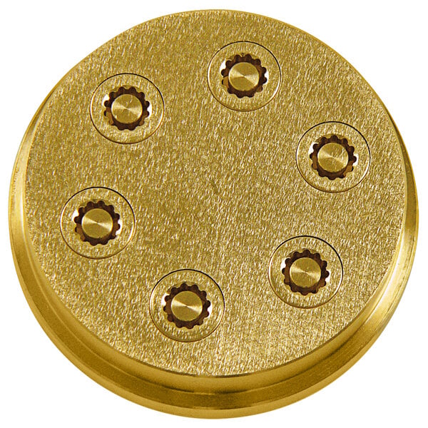 A gold circular pasta die with six holes.