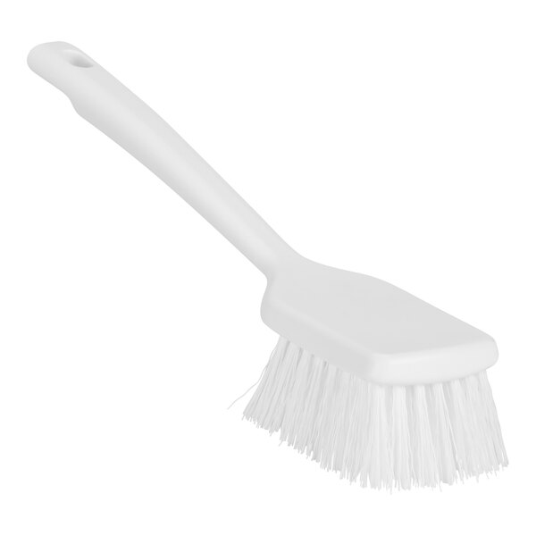 A close up of a Remco white washing brush with a short handle and stiff bristles.
