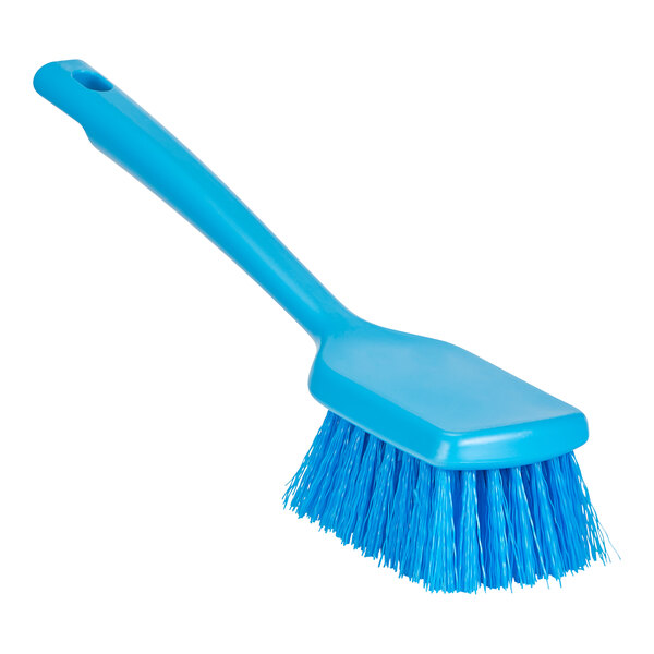 A close up of a Remco blue washing brush with short handle and stiff bristles.