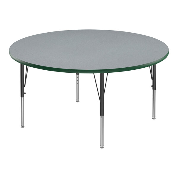 A round Correll activity table with gray top and green edge on black legs.