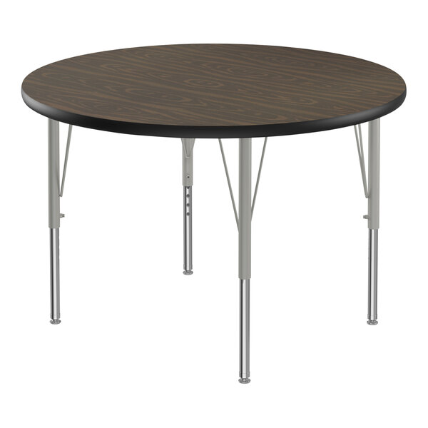 A Correll round activity table with silver metal legs and a black top.