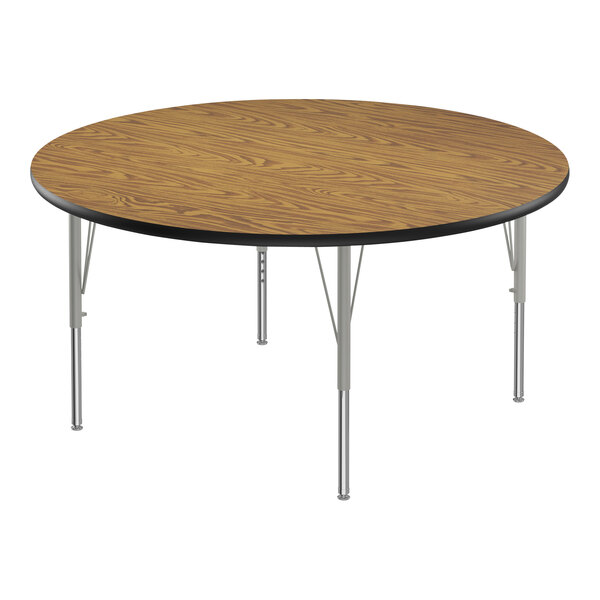 A Correll round activity table with medium oak melamine top and metal legs.