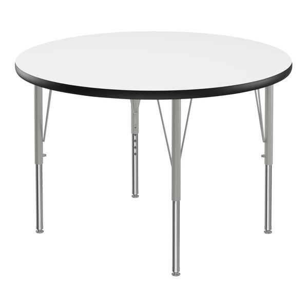 A Correll round white activity table with metal legs and black trim.
