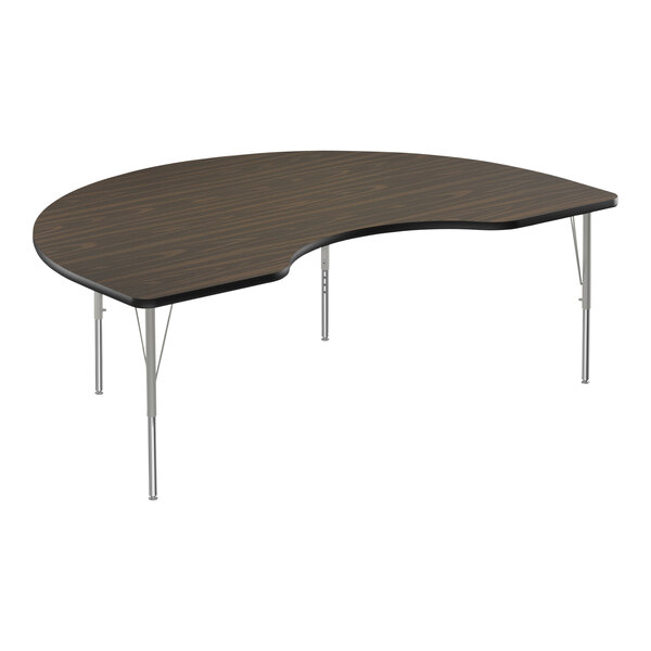 A Correll Kidney Activity Table with a curved walnut top and silver legs.