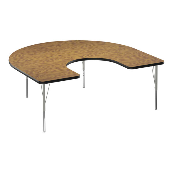 A Correll medium oak horseshoe-shaped activity table with black T-mold and silver legs.