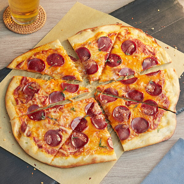 A pepperoni pizza with cheese on a table.