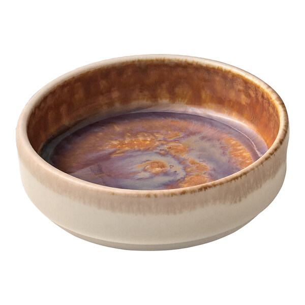 A Heart & Soul oyster porcelain bowl with a brown and white speckled surface filled with liquid.