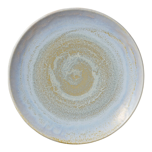 A white porcelain coupe plate with a blue swirl pattern.