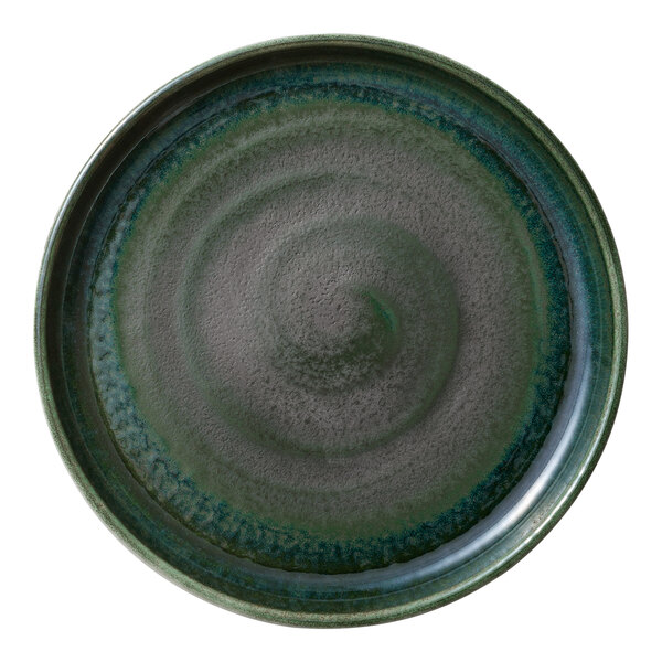 A green porcelain plate with a raised swirl pattern.