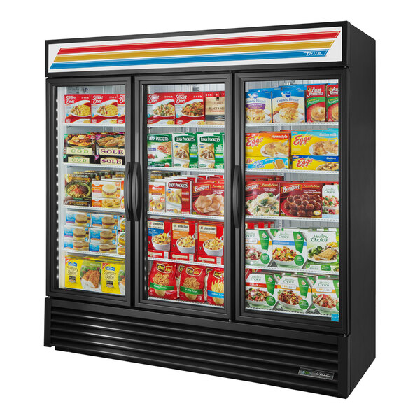 A black True glass door merchandiser freezer with food on the shelves.