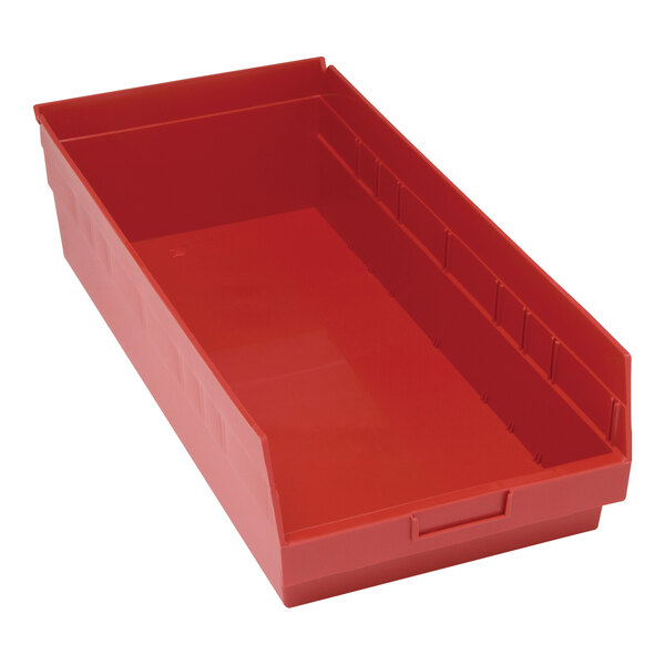 A red plastic Quantum shelf bin with red handles.