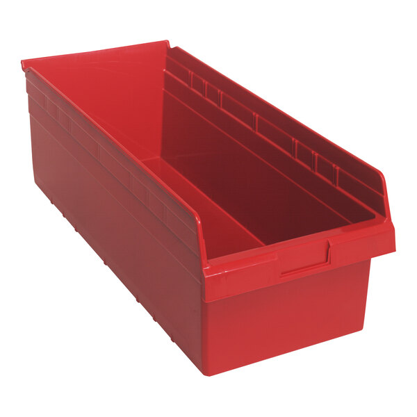 A red plastic Quantum shelf bin with a red handle.